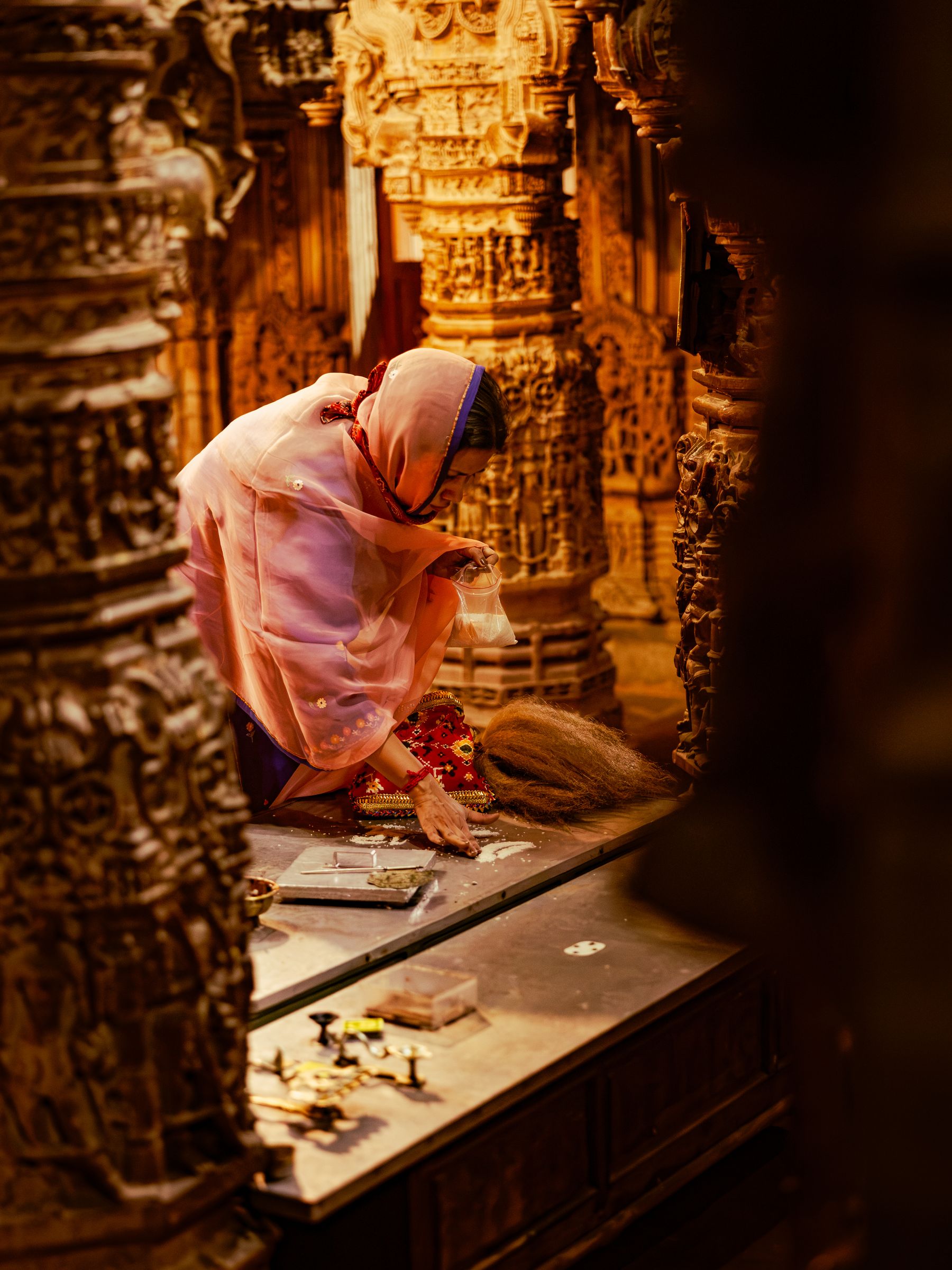 Woman Worshipping Inside Carved Stone Temple